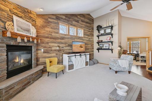 Corner gas fireplace with stone surround as the focal point.