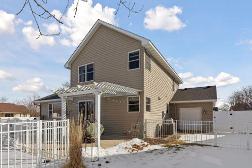 Two pergolas create shaded seating areas (both included). 3rd stall of garage has a door to the back to bring trailers or boats through to the back.