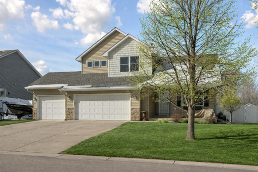 Welcoming curb appeal with covered front porch and Spacious Driveway with extra side parking pad.