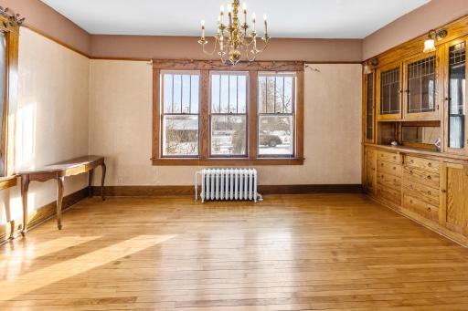 Formal dining with original wood flooring and trim