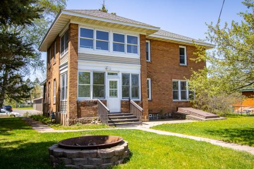 Back entrance to the home, lower level three season porch and upper level sitting room