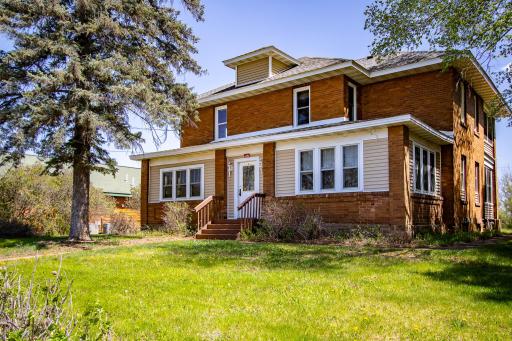 Front entrance to the home with entry porch to the left and sunroom to the right.
