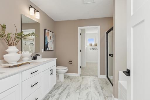 (Photo of actual model) Dual sinks and a separate tub contribute to the spa-like atmosphere of the en-suite bathroom.