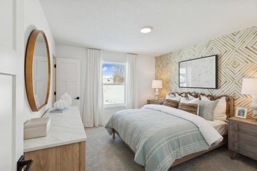 (Photo of actual model) Three secondary bedrooms can be found upstairs, just down the hall from the owner’s suite.