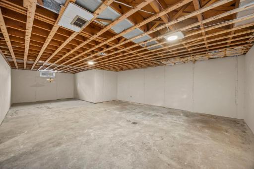 Lower level unfinsihed portion! Seller took out old tile and panelling, added drywall and the rest is ready!