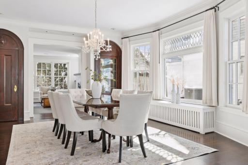 Formal dining room with chandler lighting opens to the family room