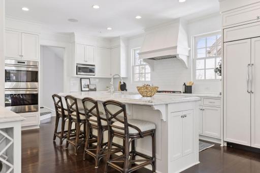 The perfect chef's kitchen with center island seating and Sub Zero refrigerator