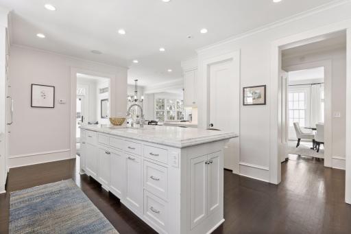 Chef's kitchen with back door mudroom access opens to family room, butler's pantry and formal dining room