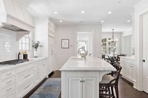 Chef's kitchen with beautiful marble countertops and walk-in pantry