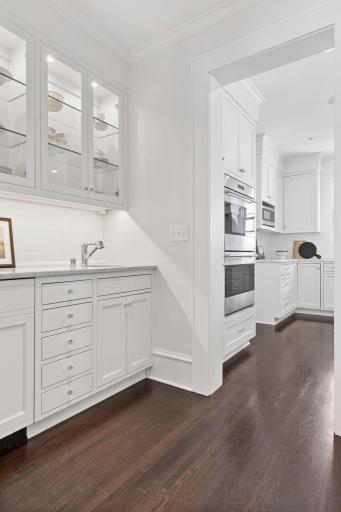 Butler's pantry with custom sink and cabinetry