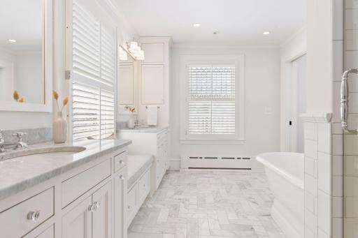Primary bath with marble floors, marble countertops, separate large walk-in shower