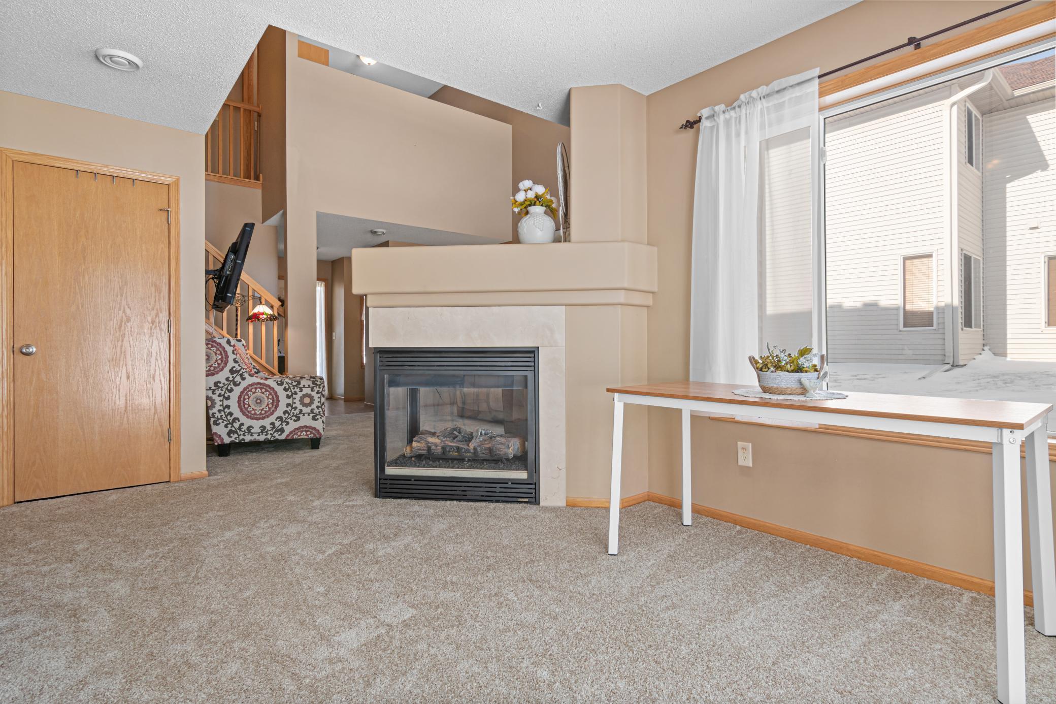 Double sided fireplace separating the dining and living rooms