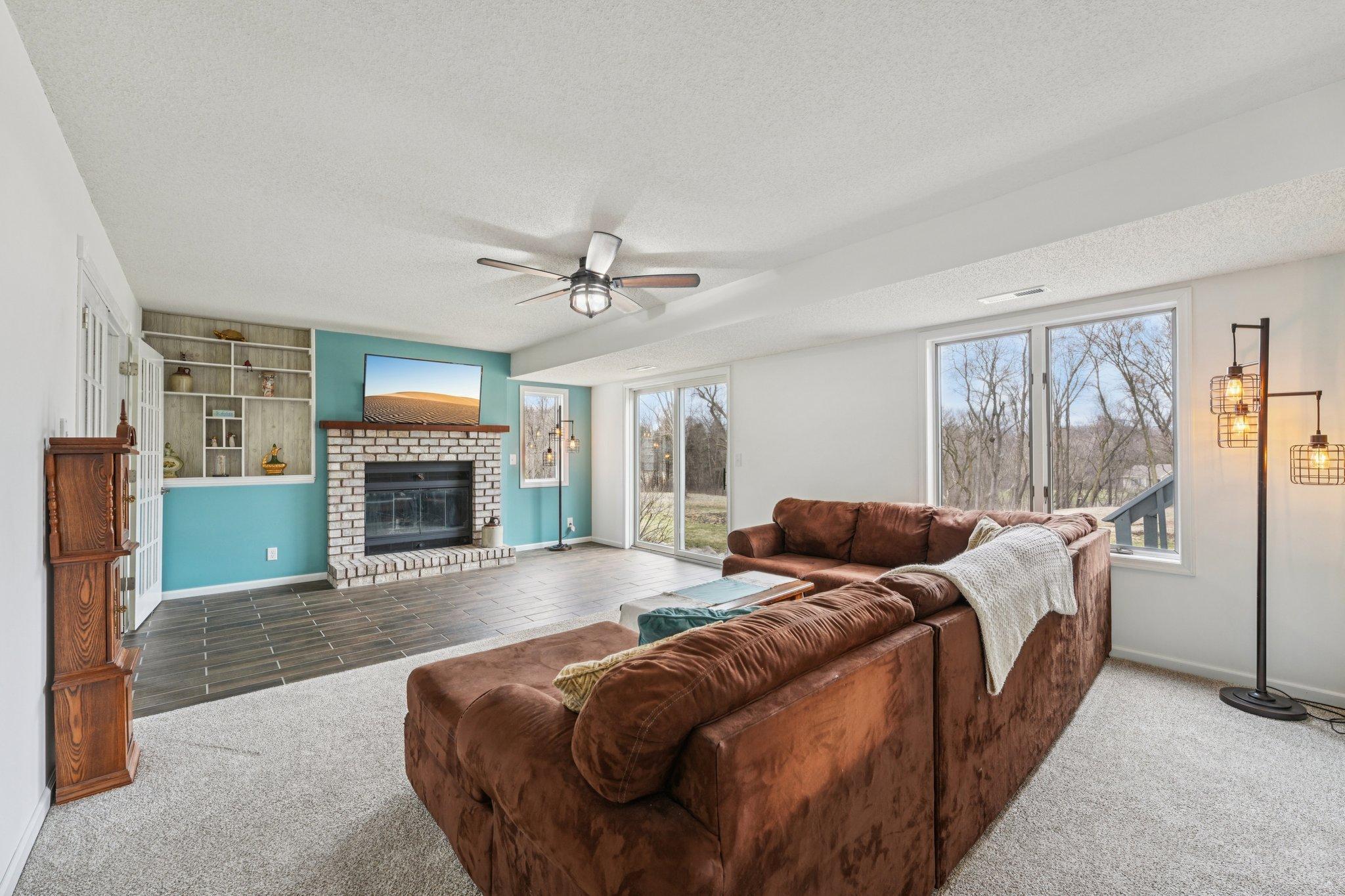 Lower Level Family Room with walk out and brick gas fireplace