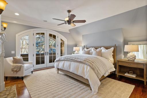 Primary bedroom with Juliet balcony and east facing lake views to capture the sunrise