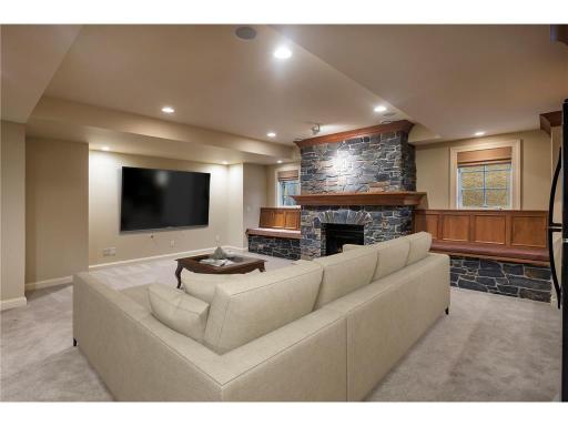 Pretty stone gas fireplace in lower-level family room