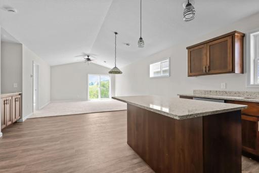 Large center island with natural granite countertops