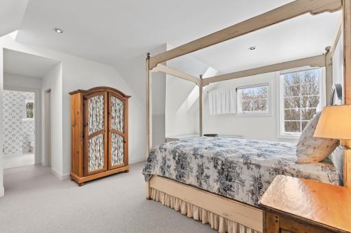 Second level bedroom with generous ceiling height, views, and ensuite bathroom