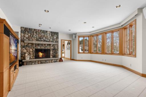 Lower level with fireplace and sunlight pouring in