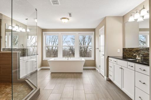 The Primary Suite offers a spa-worthy bath with two comfort height vanities and a large soaking bathtub.