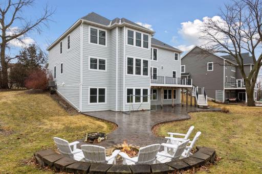 Outside, the backyard features a custom stamped concrete patio that spans the back of the home.