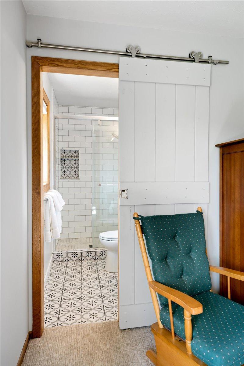 Barn door entrance to primary bath