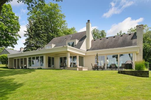 A large lakeside patio is easily accessible from multiple doors along the lakeside of the home.