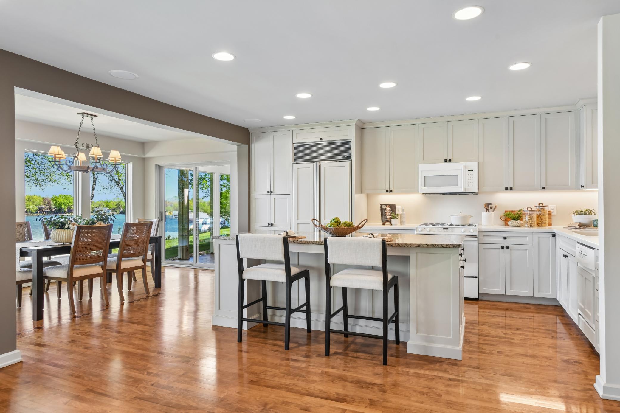 An abundance of storage and prep space will be appreciated in the kitchen featuring enameled cabinetry and solid surface counters.