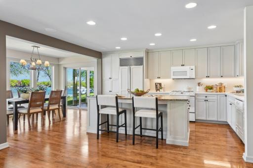 An abundance of storage and prep space will be appreciated in the kitchen featuring enameled cabinetry and solid surface counters.