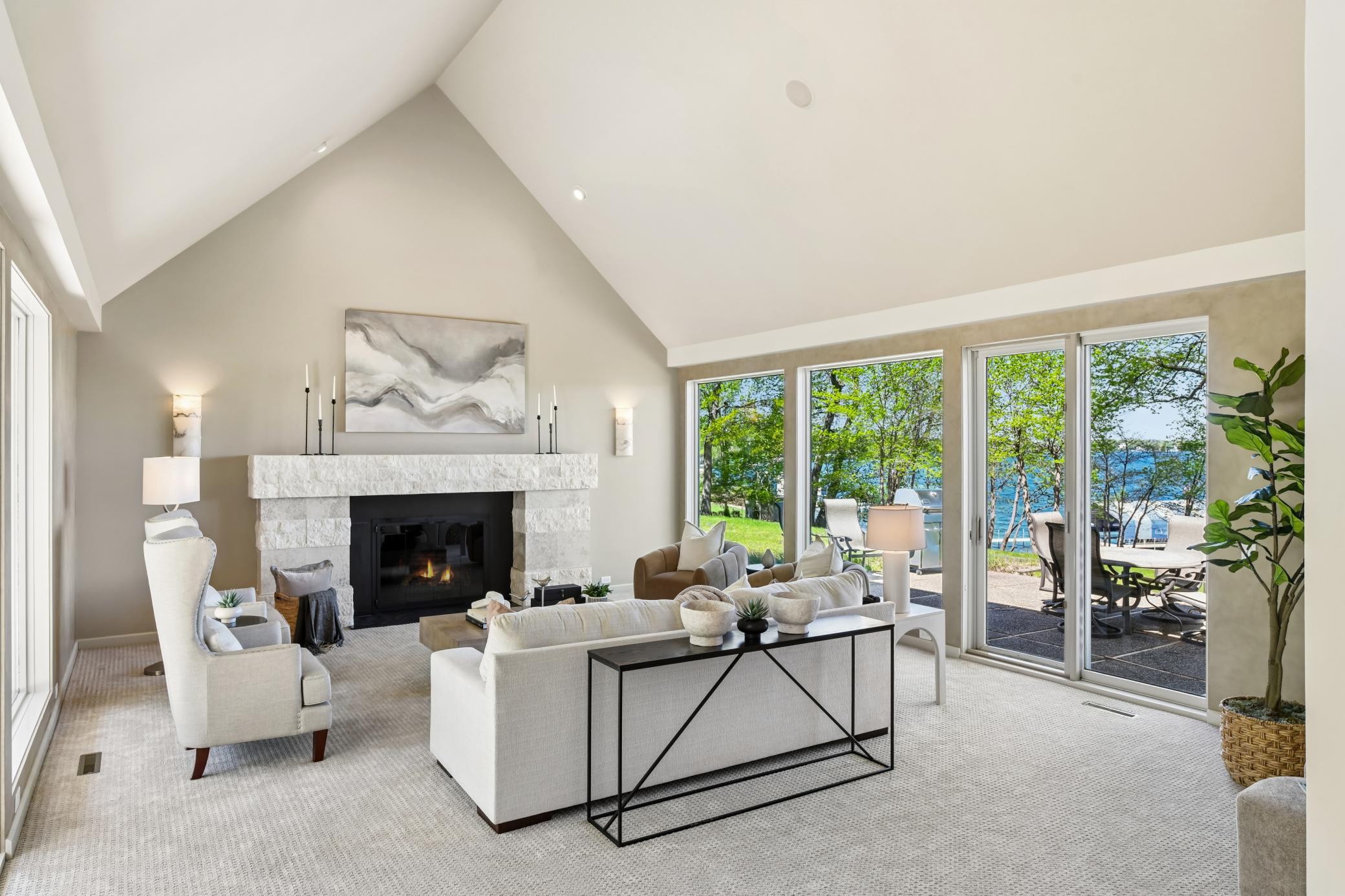 The fireplace offers a convenient gas starter and is surrounded by beautiful stone to the living room.