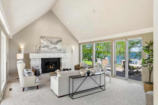 The fireplace offers a convenient gas starter and is surrounded by beautiful stone to the living room.