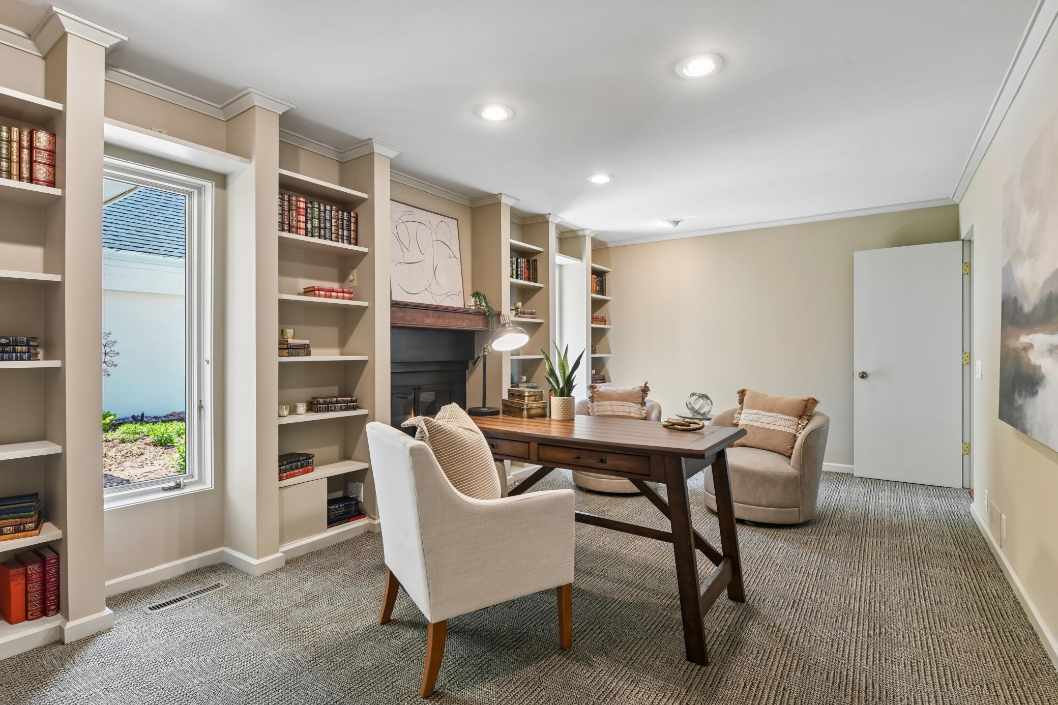 Nicely appointed, main level office features built-in bookshelves and a cozy gas fireplace. This room has also been used as a formal dining room if one would prefer.