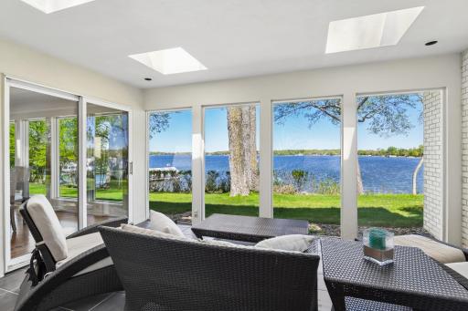 Enjoy the lakeside screen porch with convenient access to the primary bedroom, as well as the main gathering areas of the home.