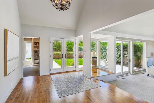 The spacious foyer showcases a vaulted ceiling and hardwood floors