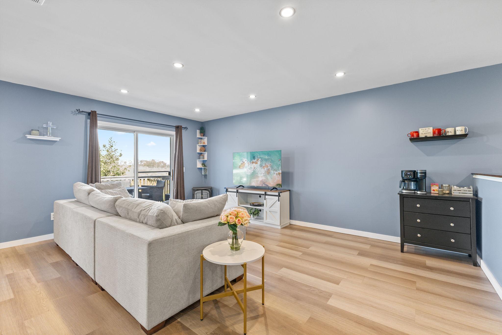 After entering through the foyer with wood floors and convenient coat closet, head up the stairs to this open living/dining/kitchen space!