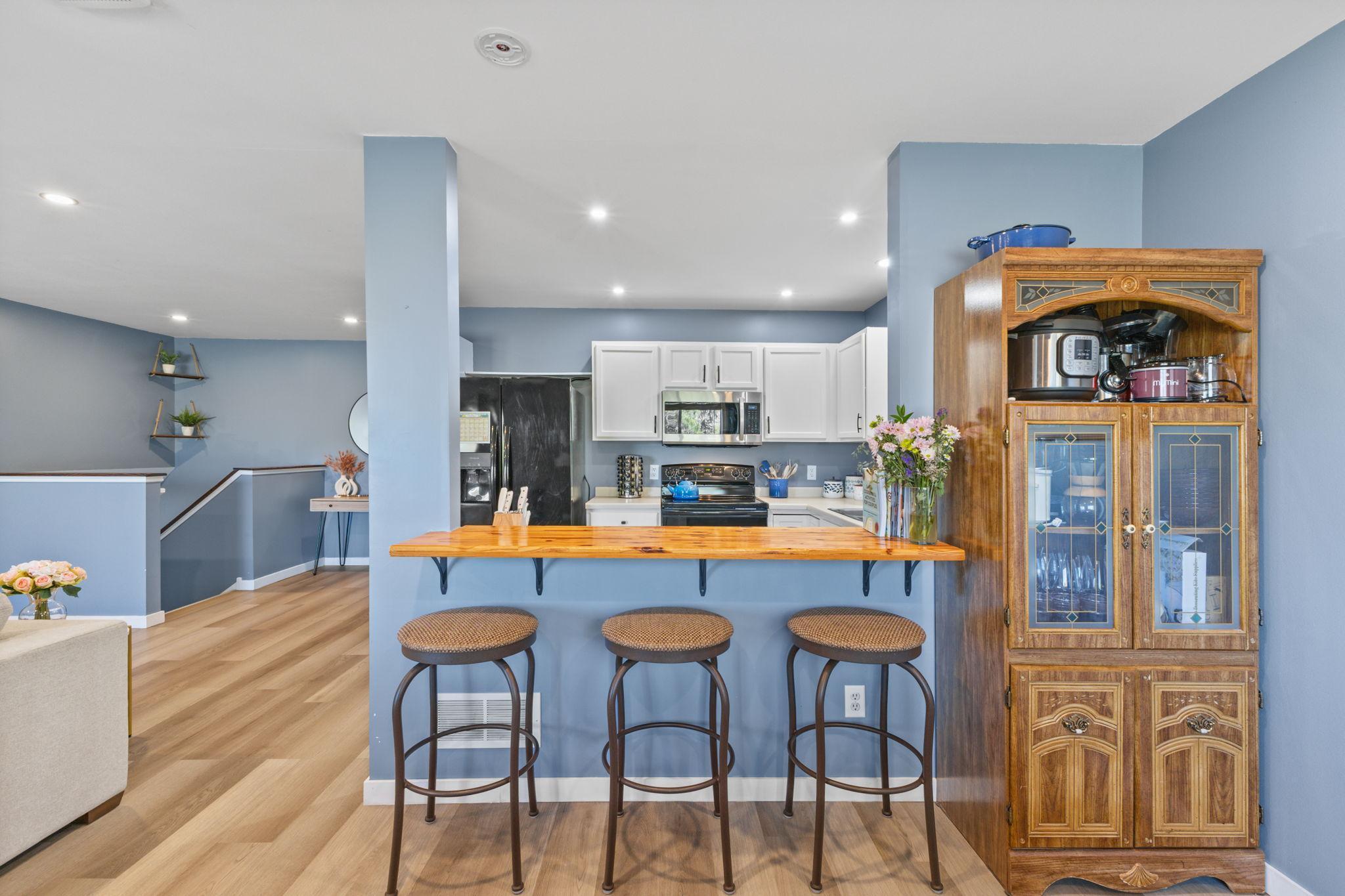 The passthrough between the kitchen and dining area provides the perfect spot for a breakfast bar.