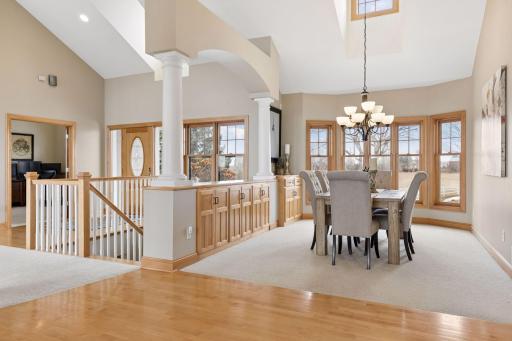 Formal dining room is elegant and bright with wall of windows and vaulted ceilings. Built in china buffet and additional cabinetry provide excellent storage, an entertainers dream.