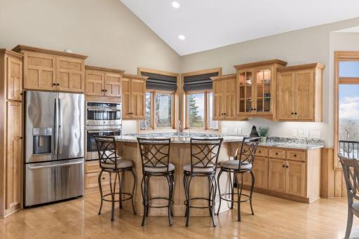 Well appointed kitchen features center island, granite tops, stainless appliances,under cabinet lighting, trash compactor and a walk in pantry.