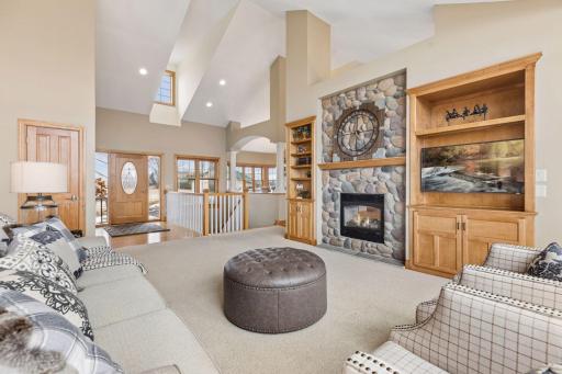 One level living at it's finest, the home has an incredible design with dramatic vaulted ceilings. Living room features a two sided gas fireplace with stone surround, custom built in cabinets & rich finishes throughout.
