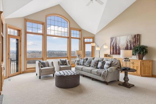 Truly spectacular views that stretch for miles, the sundrenched living room is elegant and inviting . Soaring vaults and the open airy design create an unforgettable first impression!