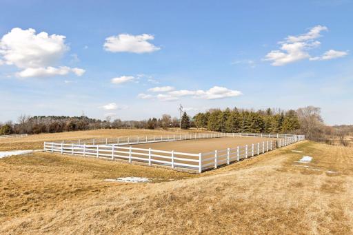 Large outdoor riding arena is 80 x 200 outlined with maintenance free fencing.