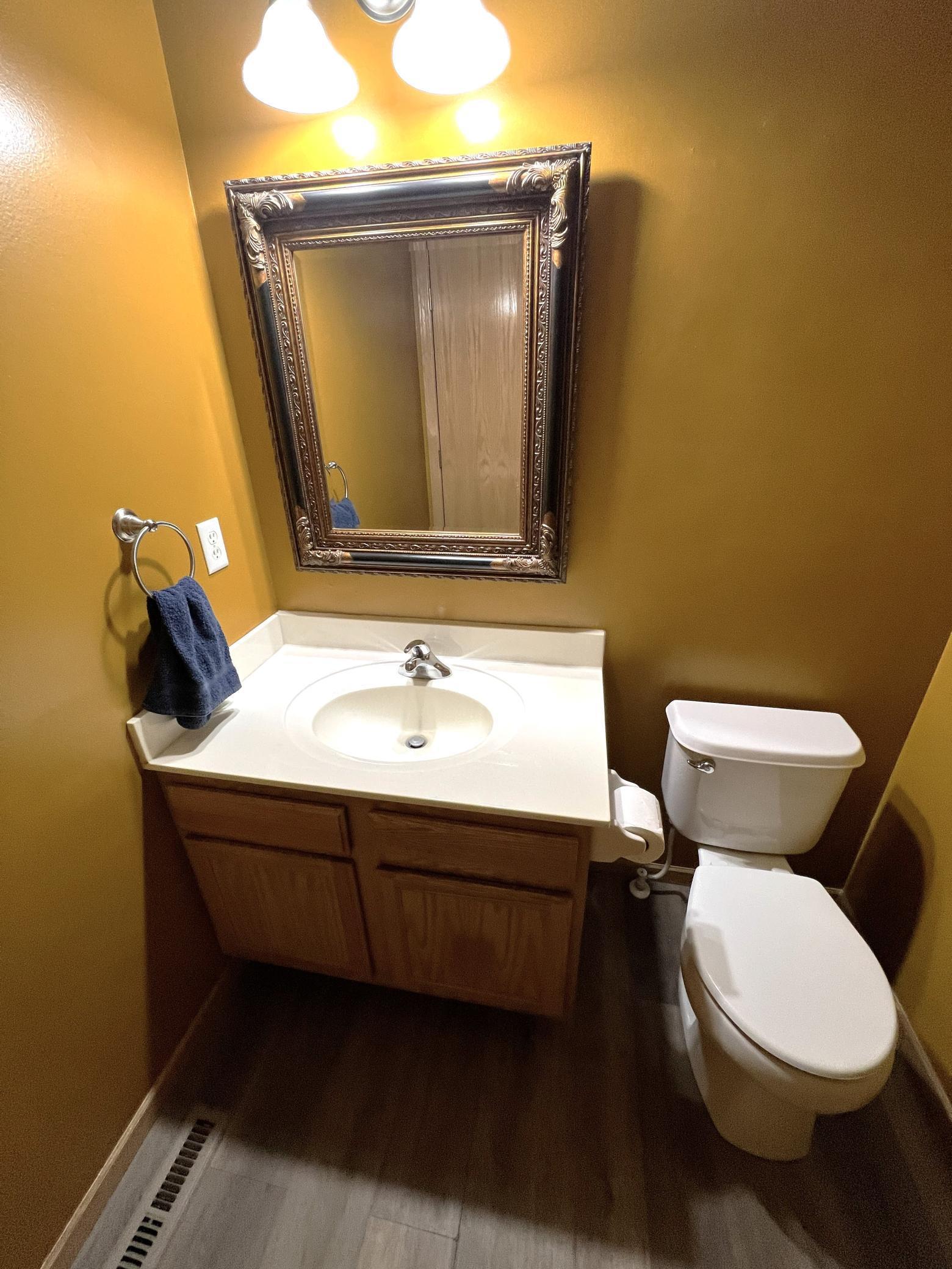 Convenient main floor half bath with new LVP flooring and fresh paint.jpg