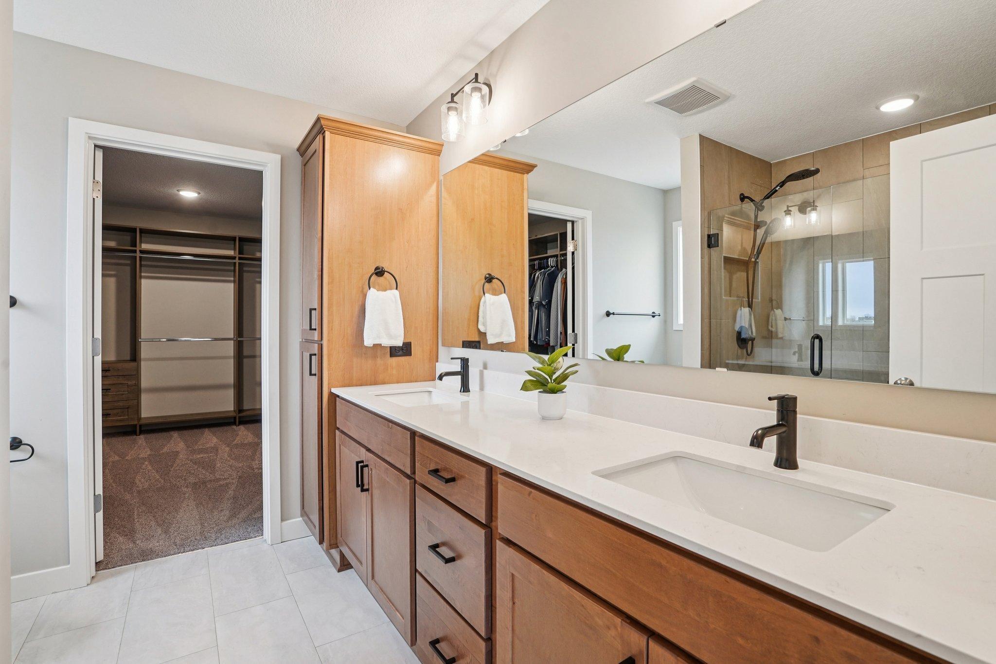 3/4 bath with dual vanity and walk-in shower.