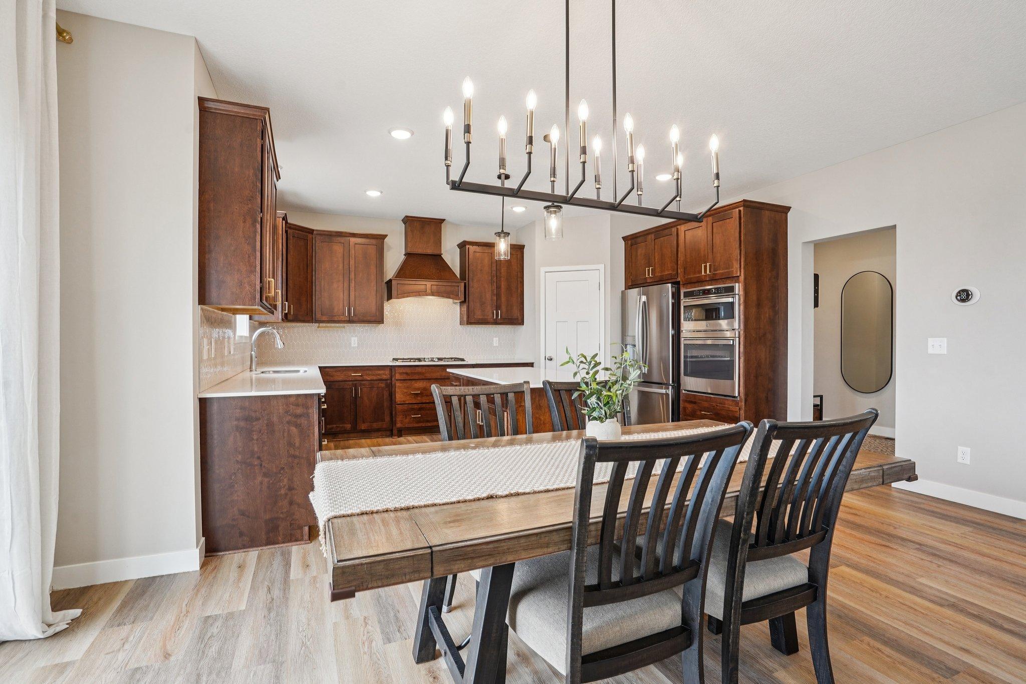 Dining room between kitchen and living spaces.