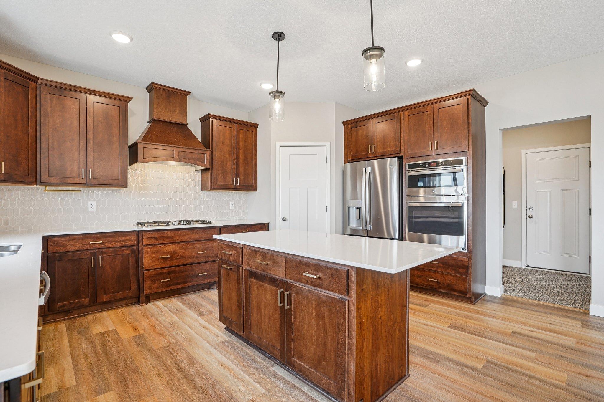 Gorgeous cabinetry and stainless appliances.