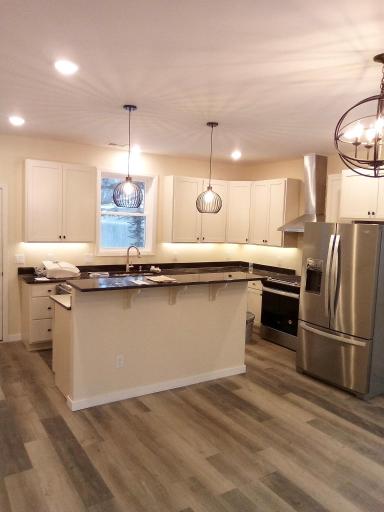 Gorgeous kitchen with SS appliances & under cabinet lighting.