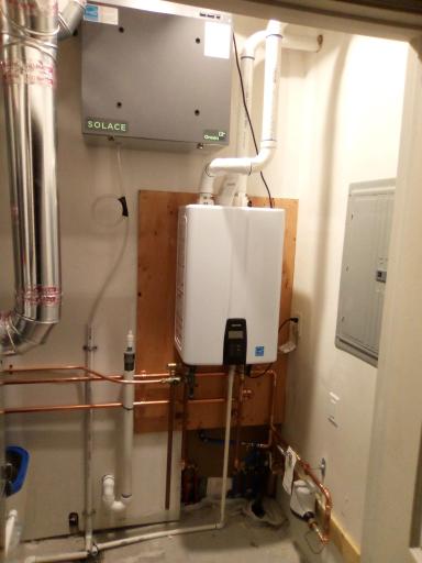 Utility room with Tankless on demand hot water heater, and air exchanger.
