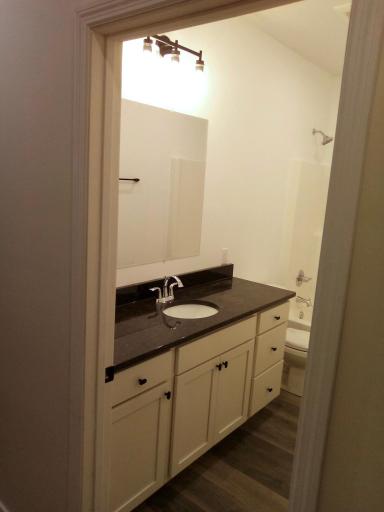 Large full bath with solid surface countertop.