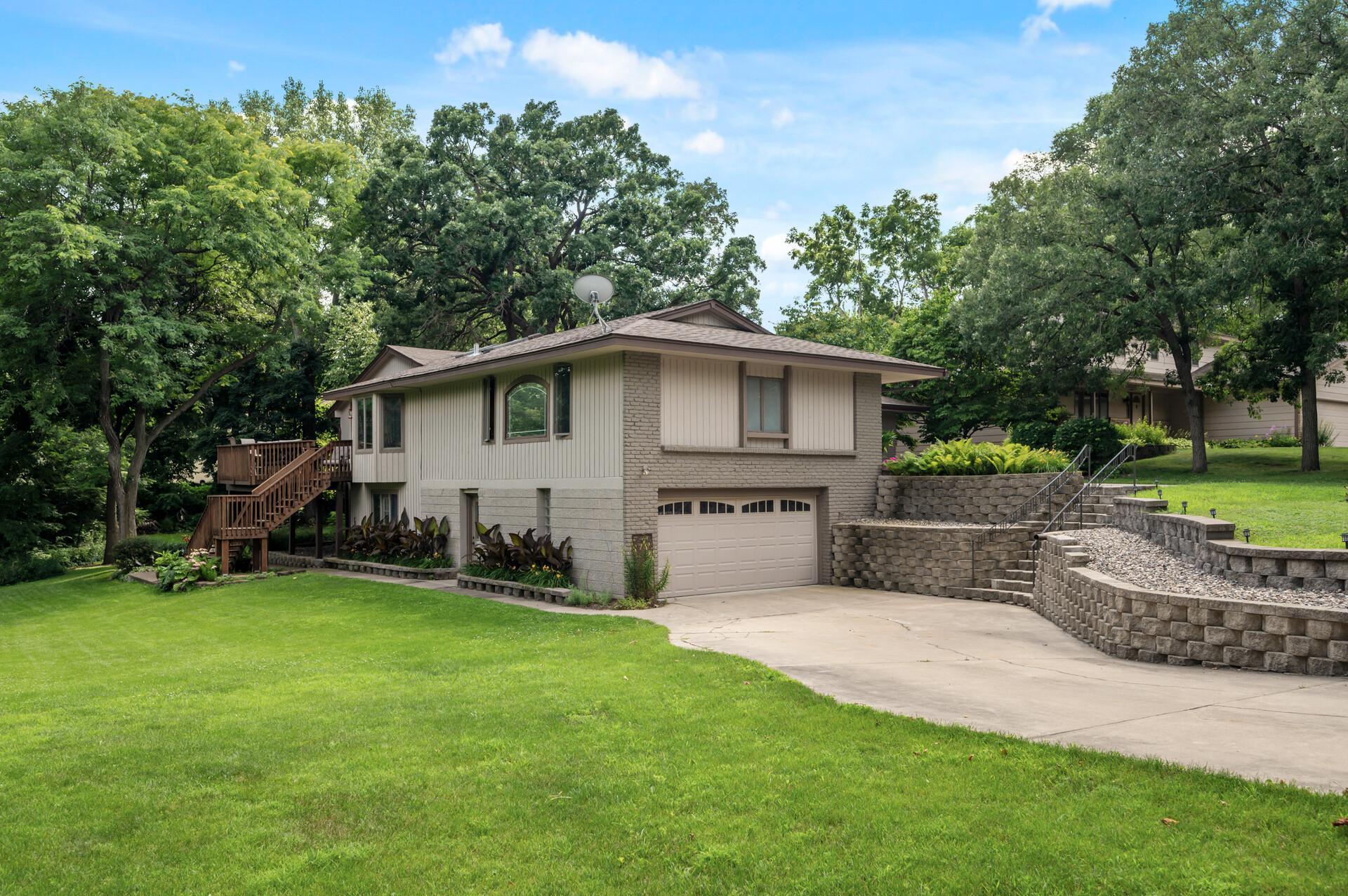 Two car garage above and below each with long concrete driveways for plenty of parking space