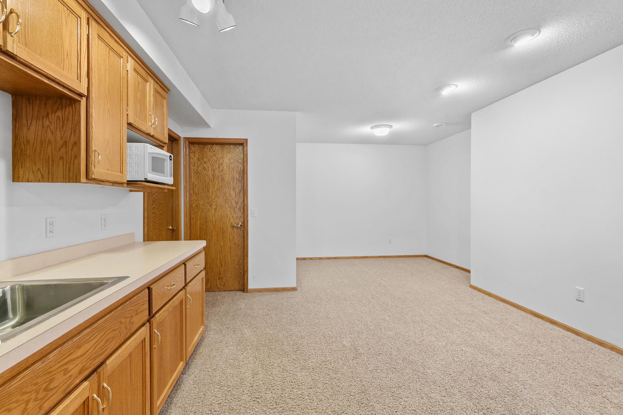 Lower level family room has open area for game table, exercise or craft area or