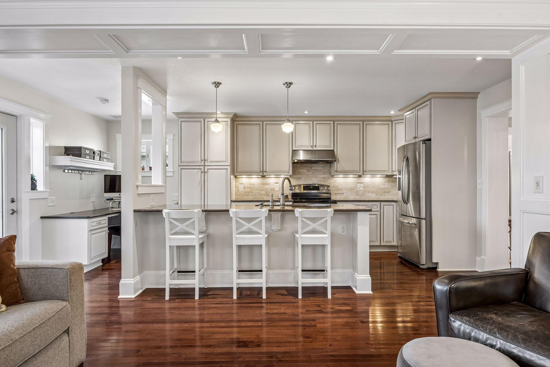 The generous kitchen peninsula creates a natural gathering space for conversation, meals, and connection.